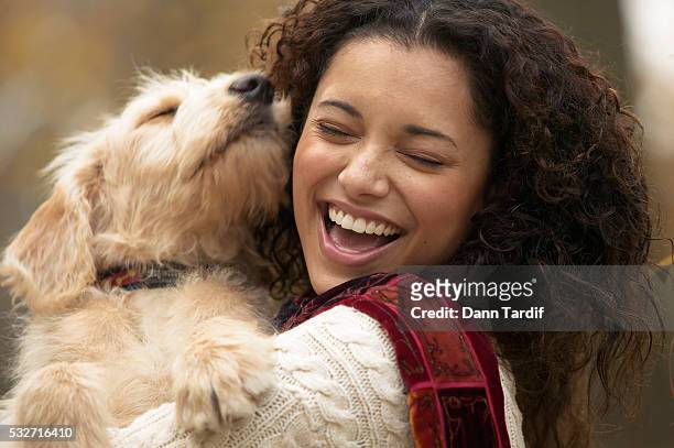 cheerful woman hugging her dog - people kissing stock pictures, royalty-free photos & images
