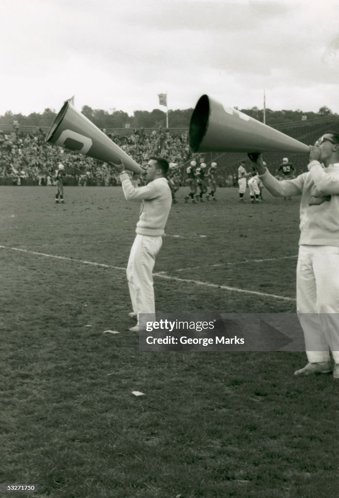 Male cheerleaders at football game