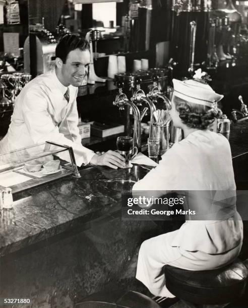 woman sitting at lunch counter - soda fountain stock pictures, royalty-free photos & images
