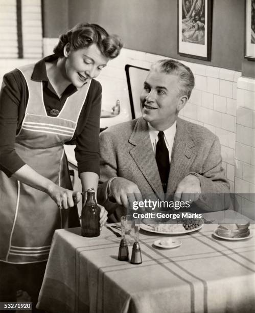 wife serving dinner to husband - madre ama de casa fotografías e imágenes de stock