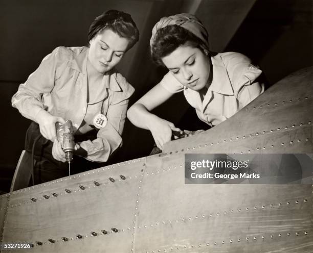 women working on ww ii aircraft assembly - história imagens e fotografias de stock