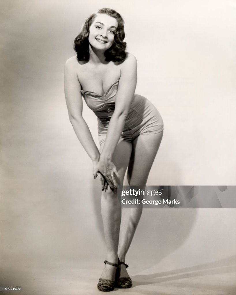 Smiling woman posing in strapless bathing suit