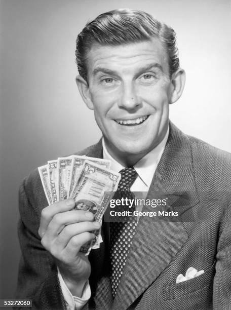 smiling man displaying his one and five dollar bills - fifty dollar bill stockfoto's en -beelden