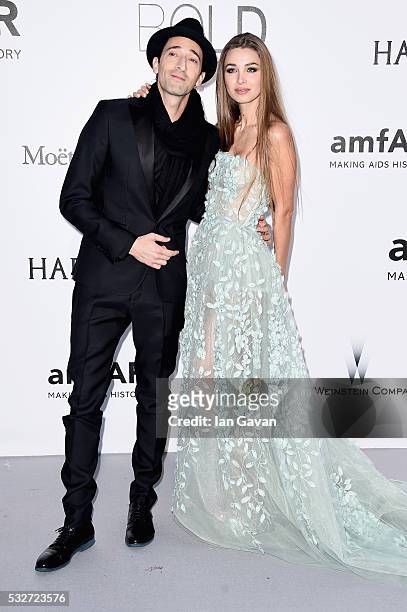 Adrien Brody and Lara Leito arrive at amfAR's 23rd Cinema Against AIDS Gala at Hotel du Cap-Eden-Roc on May 19, 2016 in Cap d'Antibes, France.
