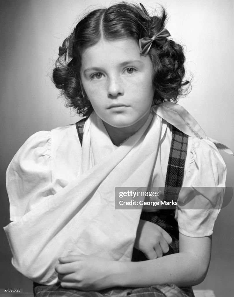 Young girl with arm in sling