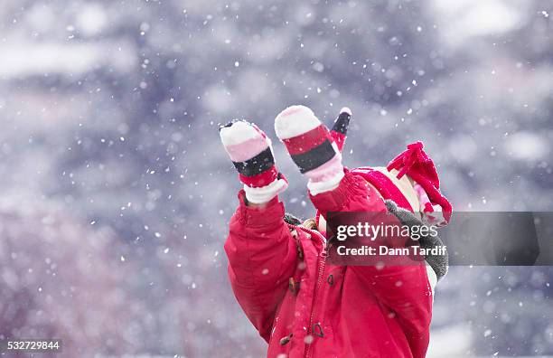 young girl catching snowflakes with her mittens - tumvante bildbanksfoton och bilder