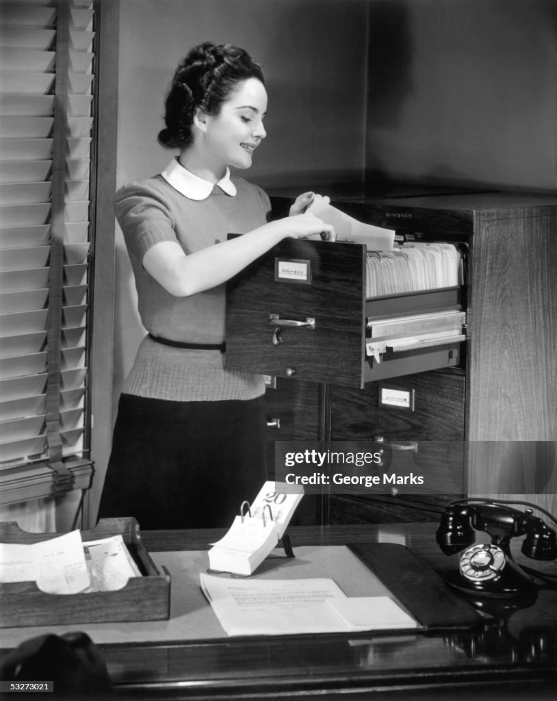 Female file clerk at office files