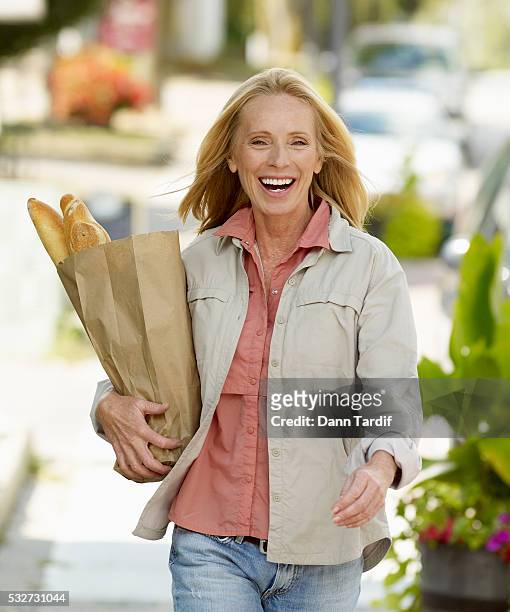 woman carrying grocery bag - baguette white stock pictures, royalty-free photos & images