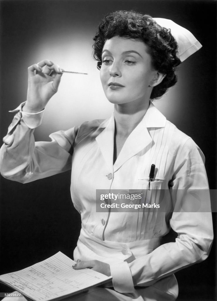 Nurse reading thermometer