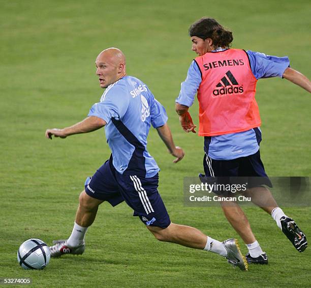 Real Madrid's Thomas Gravesen fights for the ball with his teammate during a training session on July 22, 2005 at the Teda Stadium in Tianjin, China....
