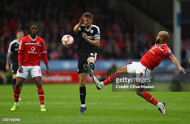 Conor Hourihane of Barnsley is tackled by Adam Chambers of Walsall during the Sky Bet League One play off, second leg match between Walsall and...