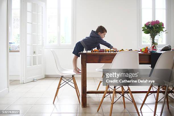 a 3 years old boy playing with cars on a table - 1 3 years stock pictures, royalty-free photos & images