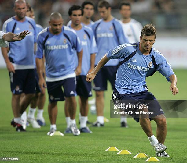 Real Madrid's David Beckham and his teammates take part in a training session at Teda Stadium July 22, 2005 in Tianjin, China. Real Madrid is on a...