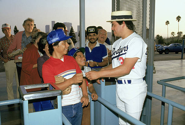 Pitcher Fernando Valenzuela of the Los Angeles Dodgers greets fans entering Dodger Stadium for a September 1986 game in Los Angeles, California.