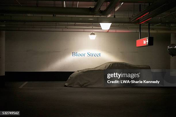 covered car in underground parking lot - abandoned car fotografías e imágenes de stock