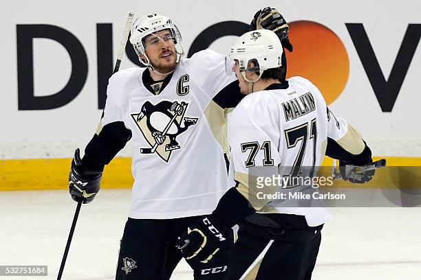 Sidney Crosby of the Pittsburgh Penguins celebrates with teammate Evgeni Malkin after scoring a goal against Andrei Vasilevskiy of the Tampa Bay...