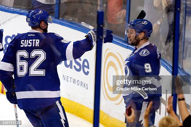 Tyler Johnson of the Tampa Bay Lightning celebrates with his teammate Andrej Sustr after scoring a goal against Matt Murray of the Pittsburgh...