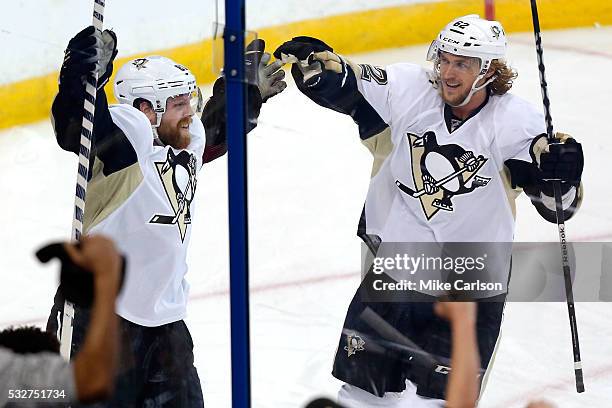 Phil Kessel of the Pittsburgh Penguins celebrates with his teammate Carl Hagelin after scoring a goal against Andrei Vasilevskiy of the Tampa Bay...