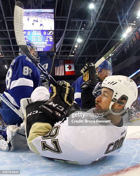 Sidney Crosby of the Pittsburgh Penguins slides in the Tampa Bay Lightning net after a play during the second period in Game Three of the Eastern...