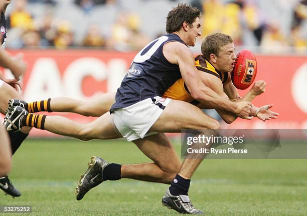 Tim Clarke for the Hawks is tackled by Jarrad Waite for the Blues during the round seventeen AFL match between the Hawthorn Hawks and the Carlton...