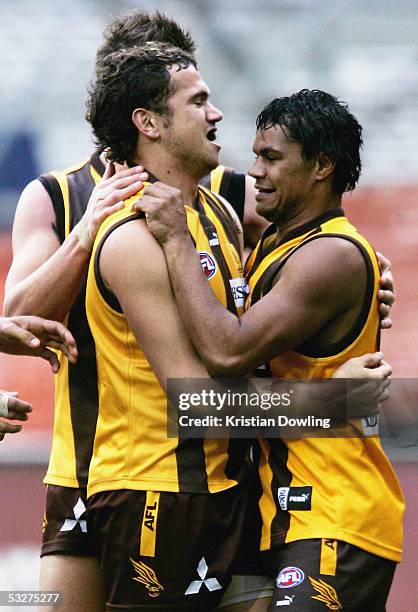 Harry Miller and Mark Williams for the Hawks celebrate a goal during the round seventeen AFL match between the Hawthorn Hawks and Carlton Blues at...
