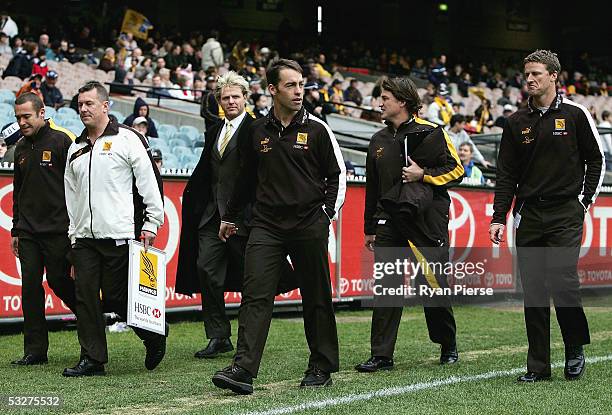 Alastair Clarkson and the Hawks coaching staff walk to the coaches box before the round seventeen AFL match between the Hawthorn Hawks and the...