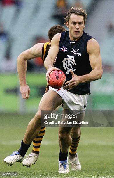 Anthony Koutoufides for the Blues in action during the round seventeen AFL match between the Hawthorn Hawks and Carlton Blues at the MCG on July 23,...