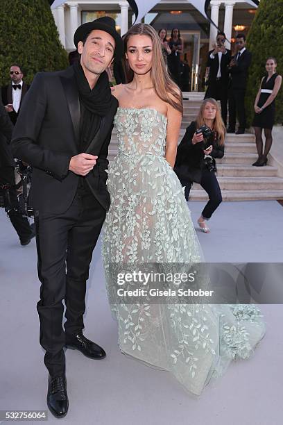 Actor Adrien Brody and Lara Leito attend the amfAR's 23rd Cinema Against AIDS Gala at Hotel du Cap-Eden-Roc on May 19, 2016 in Cap d'Antibes, France.