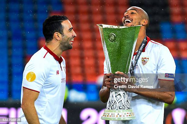 Adil Rami and Steven N'Zonzi of Sevilla FC celebrate with the trophy after the UEFA Europa League Final match between Liverpool and Sevilla at St....