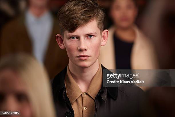 portrait of cool young man, standing in crowd - one person in crowd stock pictures, royalty-free photos & images