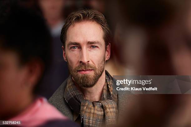 portrait of man standing in crowd - one person in crowd stock pictures, royalty-free photos & images