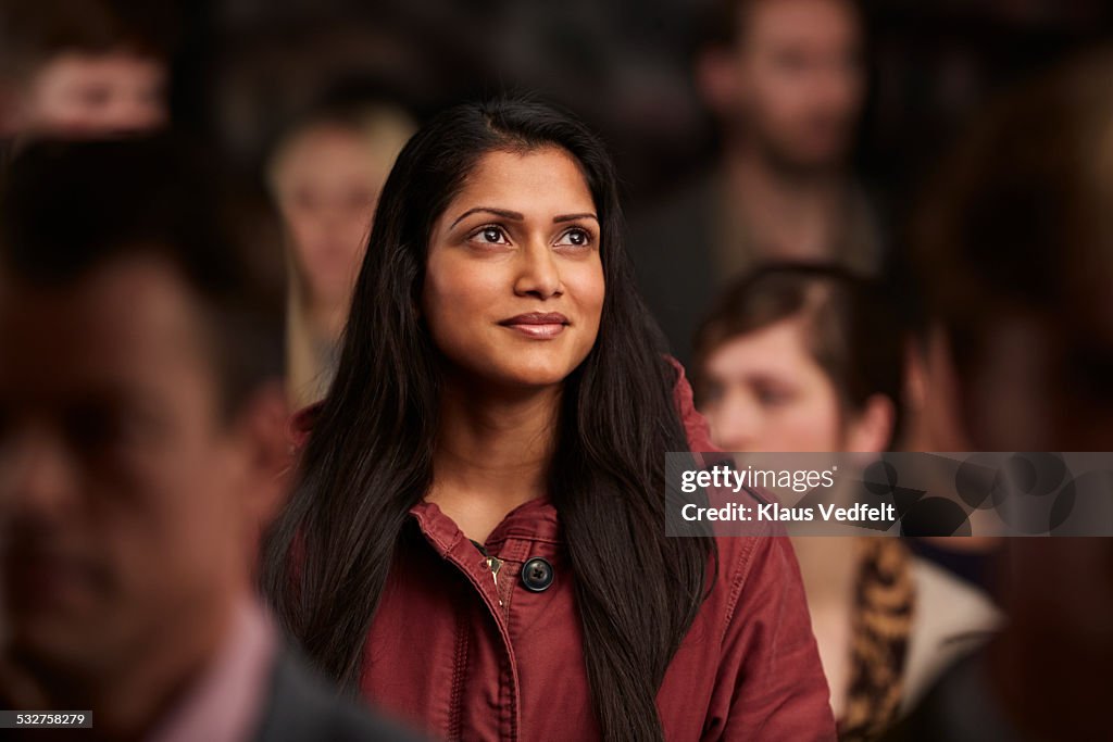 Portrait of woman smiling, while looking out