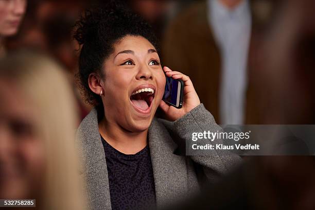 woman recieving good news on the phone - boa notícia imagens e fotografias de stock