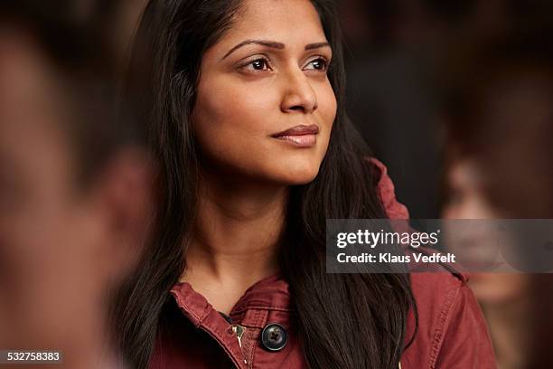 portrait of beautiful woman in crowd, looking out - geloof stockfoto's en -beelden