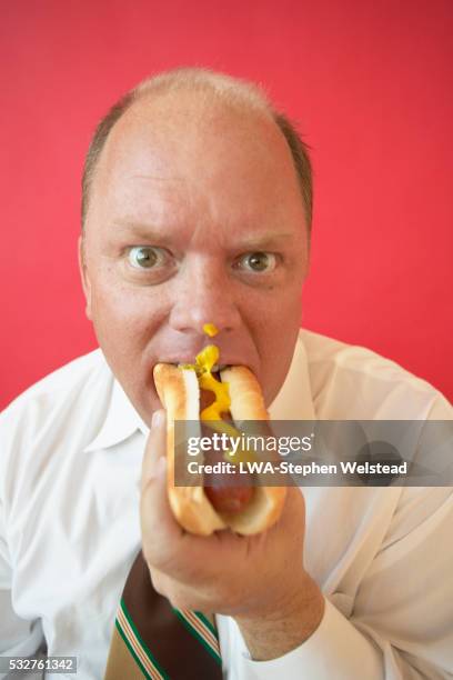 businessman eating hot dog - white shirt stain stock pictures, royalty-free photos & images