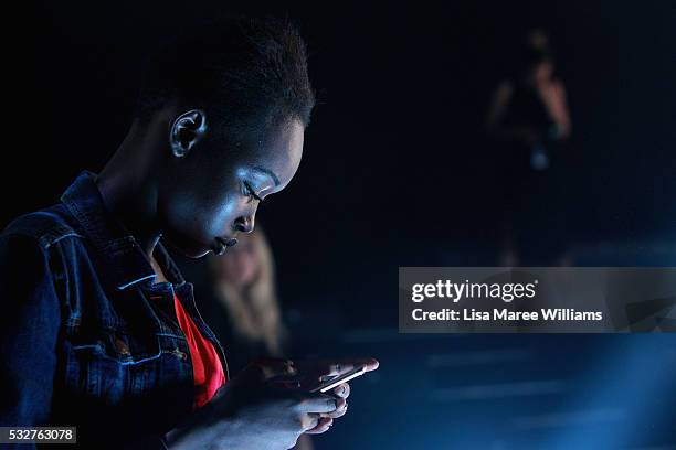 Model uses her phone backstage ahead of the We Are Handsome show at Mercedes-Benz Fashion Week Resort 17 Collections at Carriageworks on May 19, 2016...