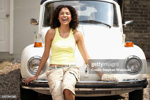 woman sitting on car bumper - bumper stock pictures, royalty-free photos & images