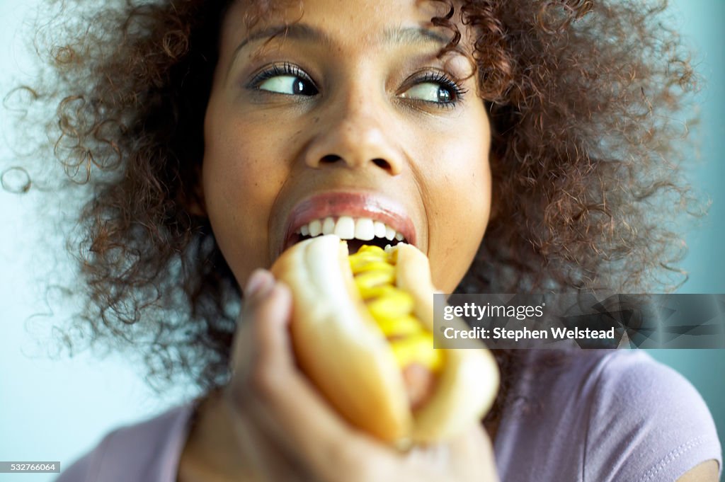 Woman Eating Hot Dog