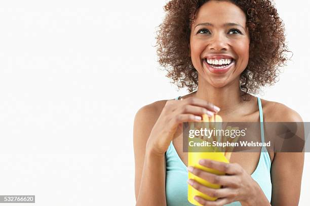 woman eating french fries - french fries white background stock-fotos und bilder