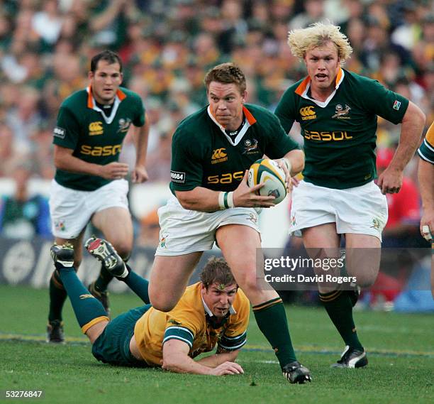 John Smit, the Springbok captain avoids a challenge from Daniel Vickerman as he powers forward during the Nelson Mandela Challenge Plate...