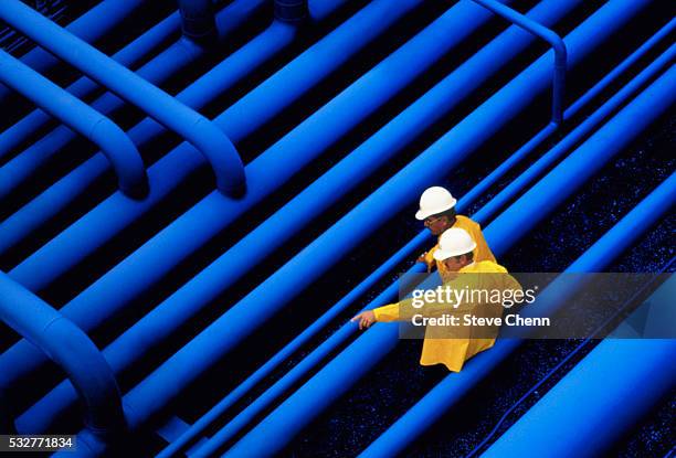 oil workers in discussion - parallel stock pictures, royalty-free photos & images