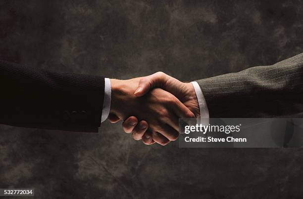 businesspeople shaking hands - handshake closeup stock pictures, royalty-free photos & images