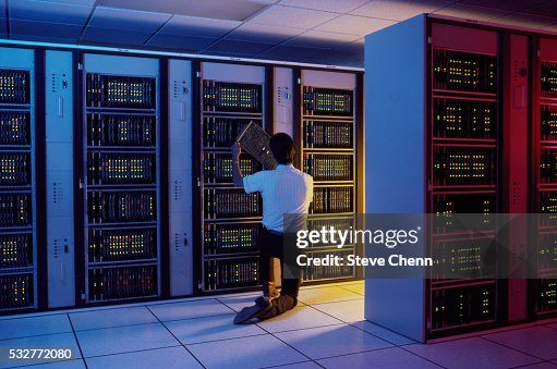 Man Inspecting Mainframe Computer Man Inspecting Mainframe Computer