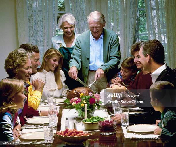 family at thanksgiving dinner - old fashioned thanksgiving stock-fotos und bilder