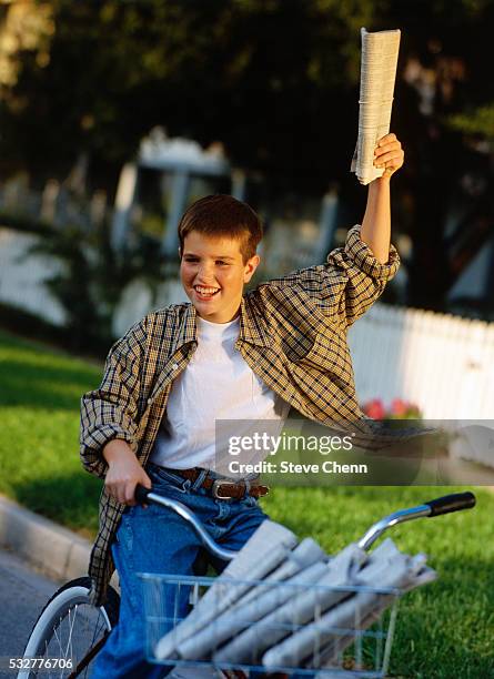 paperboy delivering newspapers - newspaper boy stockfoto's en -beelden