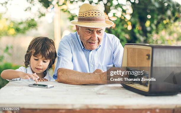 portrait of a small boy with his grandfather - radio fotografías e imágenes de stock