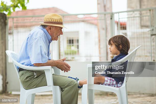 portrait of a small boy with his grandfather - abuelos fotografías e imágenes de stock