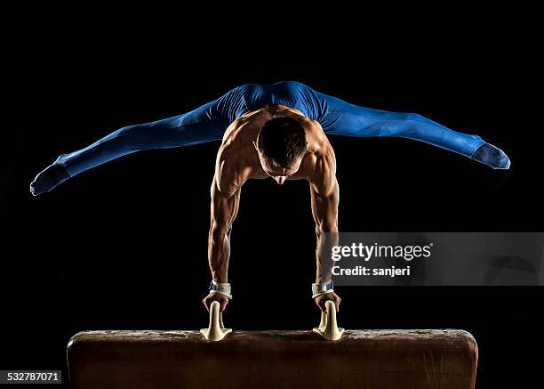 male gymnast doing handstand on pommel horse - gymnastics horse stock pictures, royalty-free photos & images