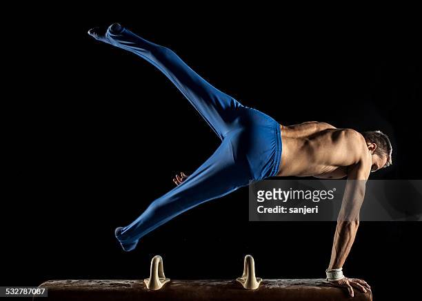 male gymnast doing handstand on pommel horse - artistic gymnastics stockfoto's en -beelden