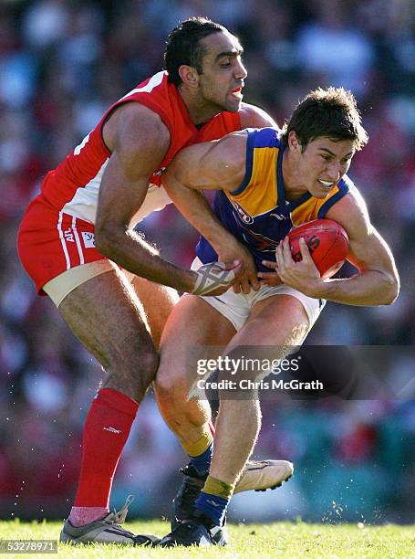 Tyson Stenglein of the Eagle is tackled by Adam Goodes of the Swans during the round seventeen AFL match between the Sydney Swans and the West Coast...